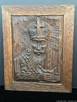 Full front view of the wood panel showing the carved King of Hearts figure with the frame.