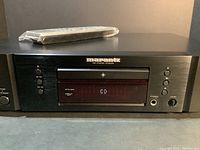 Front view of Marantz CD5004 CD player with remote on top