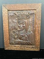 Front view of the carved wood panel showing the Queen of Hearts figure in natural wood finish within a textured frame.