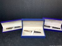 Three Waterman pens displayed in original branded boxes, showing pen designs and colors.