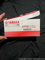 Photo of the original Yamaha parts and accessories box showing the brand, part number, and label details.