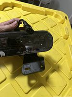 Black LED light showing connector plug at one end with lens and mounting bracket attached.