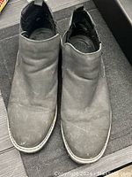 Top view of pair of men's black ankle boots, used condition, size 11.