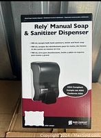 Photo of sealed boxed dispenser showing front facing image, product name, capacity, compliance info.