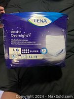 Photo of TENA ProSkin Overnight underwear package in blue and purple packaging with size Large and super absorbency details.