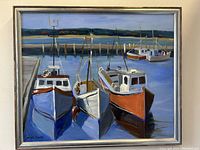 Full view of painting depicting three boats at dock within silver frame