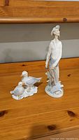 Lladro Don Quixote and Seagulls porcelain figurines shown on wooden surface, highlighting overall appearance and size