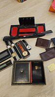 Overall lot including wristwatches, valet trays, business card holders, watch display stand