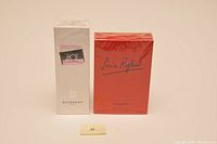 Photo of two boxed fragrances on a plain background: Givenchy Hot Couture Cologne box and Sonia Rykiel Gel Perfume box, both sealed in original wrapping.