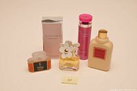 Five bottles including colognes and body creams by Krizia, Marc Jacobs, Ralph Lauren, Givenchy.