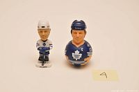 Photo of two Mats Sundin hockey bobble heads, one full figure and one bust style on white background.
