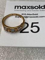 Top-down view of ring on MaxSold card showing layout of three opals