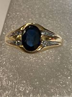Front view showing oval blue sapphire and surrounding diamonds