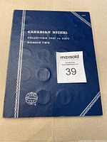 Closed blue Whitman Canadian nickel collection album cover with embossed coin design and title