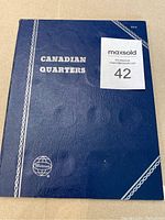 Blue Whitman Canadian quarters album cover with white text and decoration.