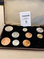 Full view of the British 1968 specimen coin set with ten coins in a case, showing two missing coin slots