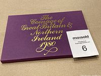 Purple presentation folder with gold embossed text 'The Coinage of Great Britain & Northern Ireland 1980' on front.
