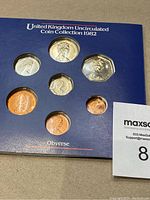 Front side of the 1982 UK uncirculated coin set showing the obverse side of coins including portraits of Queen Elizabeth II.