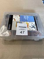 Closed plastic box with a label '47' sitting on a table