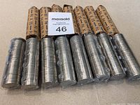 Fifteen rolls of Canadian nickels with visible coin ends showing 'CANADA' inscribed.
