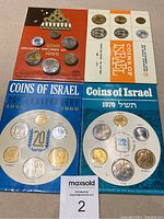 Four cardboard-packaged sets of Israeli coins from 1968 and 1970 front side showing arrangement of multiple coin denominations and commemorative themes.