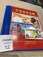 Blue and red hardcover World Paper Money album with Chinese and English text on the cover, highlighting 30 countries and regions.