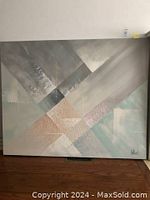 Full view of the abstract geometric painting showing intersecting shapes and muted color palette.