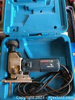 Bosch corded jig saw inside blue carrying case showing model number and cord