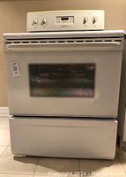 Front view of freestanding range with storage drawer