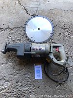 Full view of Porter-Cable Tiger Saw and separate circular saw blade on concrete floor