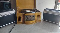 Front view of Philco wooden turntable with CD/cassette and two Sears portable 8 track players