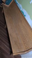 Photo of single wooden church pew showing length and finish