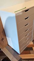 White Ikea storage cabinet with six drawers shown from side angle illustrating drawer design and cabinet condition.