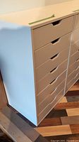 White Ikea storage unit with multiple drawers photographed from the side and front showing drawer handles and clean lines.