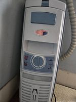 Close-up of canister vacuum top control panel with suction dial and filter cover