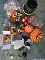 Full lot overview showing plastic pumpkins, ghosts, bows, artificial berries, spider decoration, and Halloween-themed bowls
