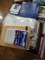 Photo showing Avery fabric labels pack, manila folders, and assorted paper and filing supplies