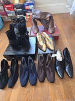 Photo showing all footwear in the lot arranged on the floor, including boots and heels in various colors and styles.