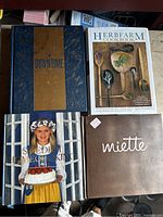 Photo showing four cookbooks, two missing covers, titles visible for all