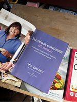 Open book showing title page and photo of Ina Garten in Barefoot Contessa at Home.