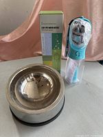 Overview photo showing stainless steel dog water bowl and 5-in-1 portable pet water bottle with packaging