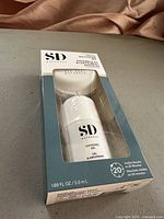 Front view of unopened SD Essentials Whitening Gel Kit in box showing whitening gel and mouth tray.