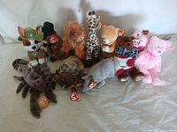 Overview of 10 assorted Beanie Babies featuring various animals, showcasing brand tags and condition.