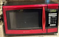 Red and black Emerson microwave with keypad