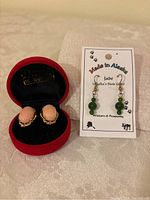 Pair of oval pink stone earrings in red velvet case and pair of Alaska jade earrings on display card