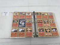 Open binder showing two pages filled with assorted Pokémon cards including multiple copies of the same types.
