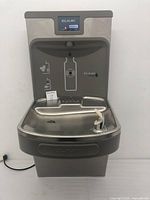 Full front view of the ELKAY drinking fountain and bottle filler station unit showing stainless steel basin and spout with sensor bottle filler area above.