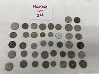 Full lot of 38 foreign coins displayed on white background with label 'Maxsold Lot 24'.