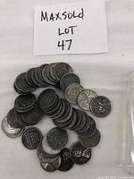 Coins spread out showing reverse wheat ear design and silver metallic appearance.