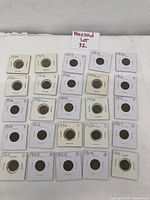 Lot overview showing 24 Lincoln Wheat pennies from 1910-1936 in individual holders